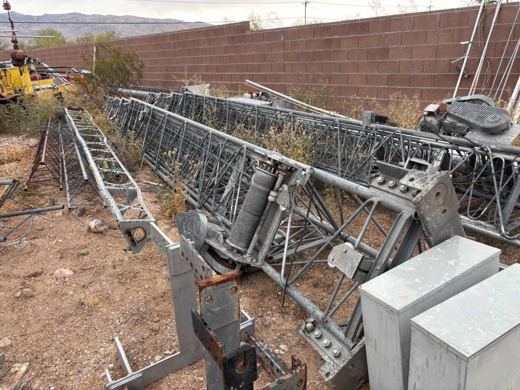 Assorted radio tower components and structural steel parts for amateur radio tower assembly