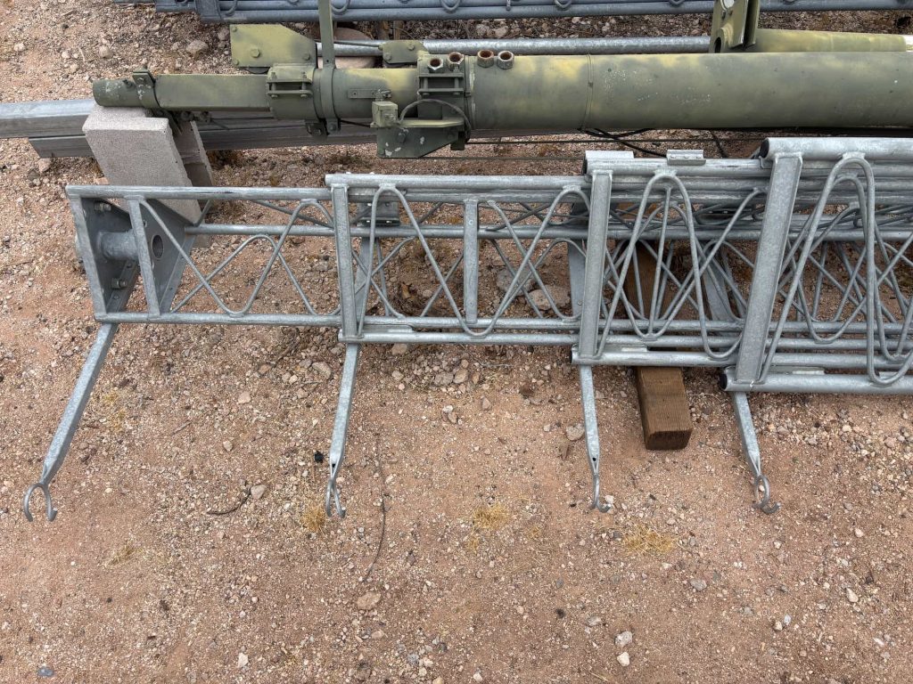 Steel ROHN-style radio tower sections stored outdoors for amateur radio and antenna tower projects
