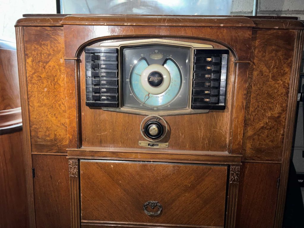 Vintage wooden console radio with large circular tuning dial and decorative cabinet, ideal for antique radio collectors